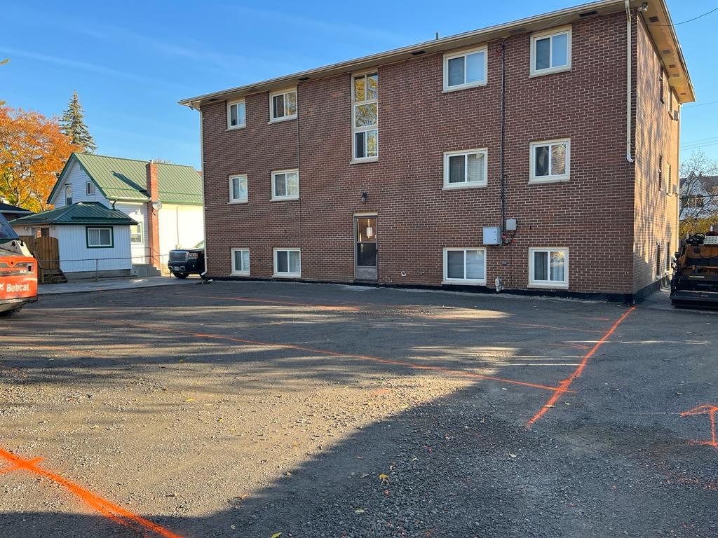 preparing an apartment building's parking lot for paving