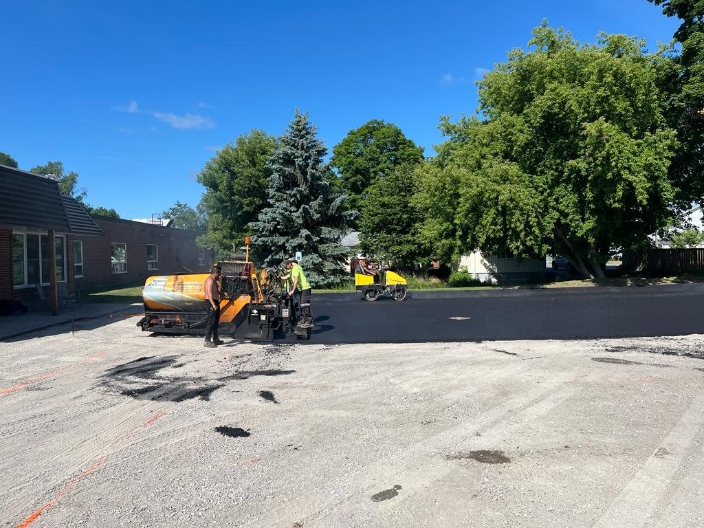 Genesis team working on paving a parking lot