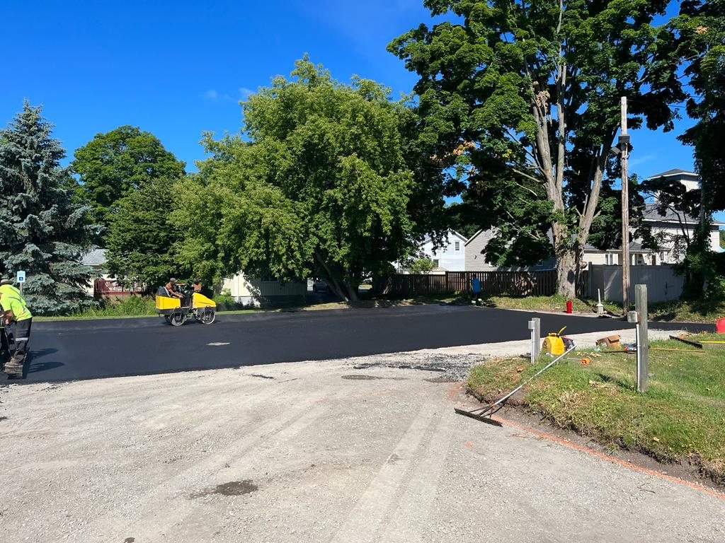 Genesis Paving working on an asphalt parking lot
