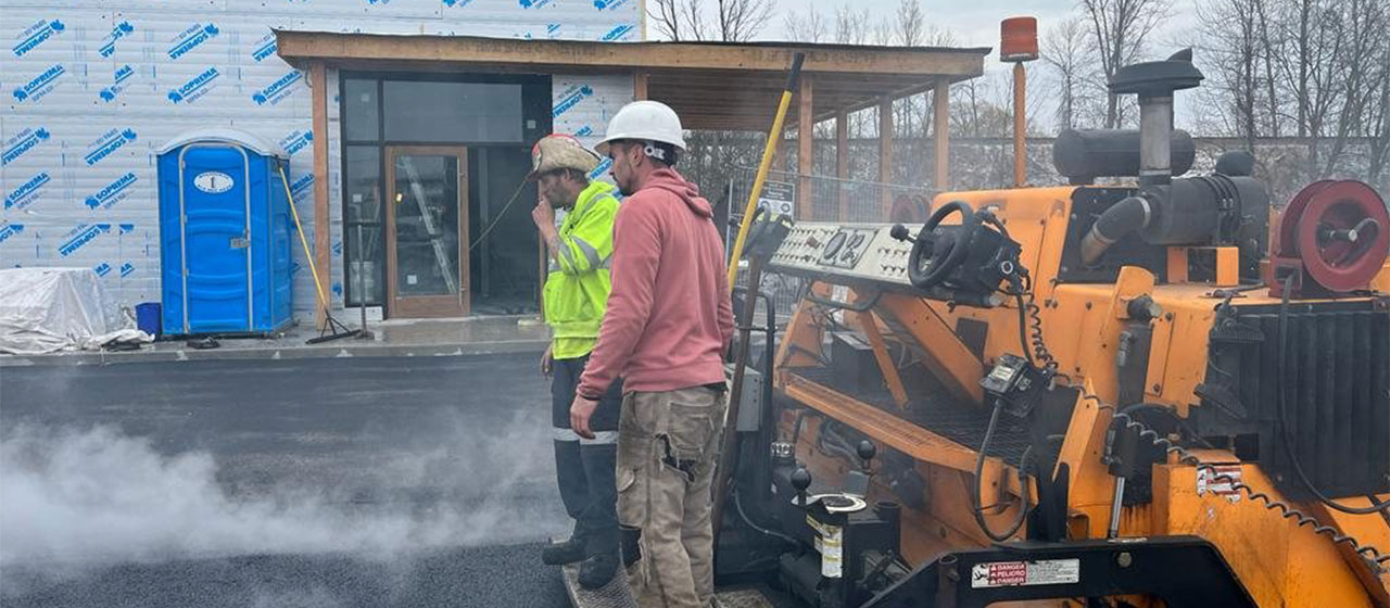 Genesis Paving team providing services for a commercial building parking lot