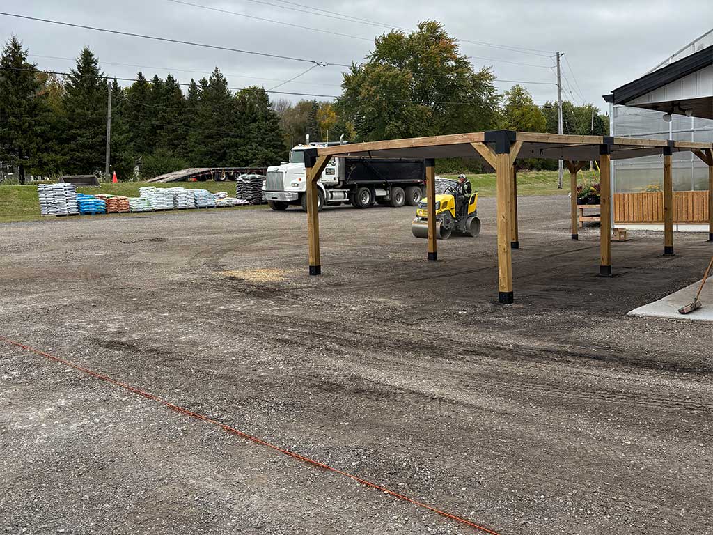 Compressing base for paving preparation at Mike and Lori's Garden Centre