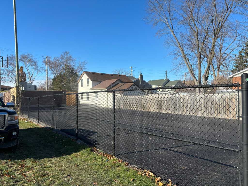 Completed commercial paving project, between two fences