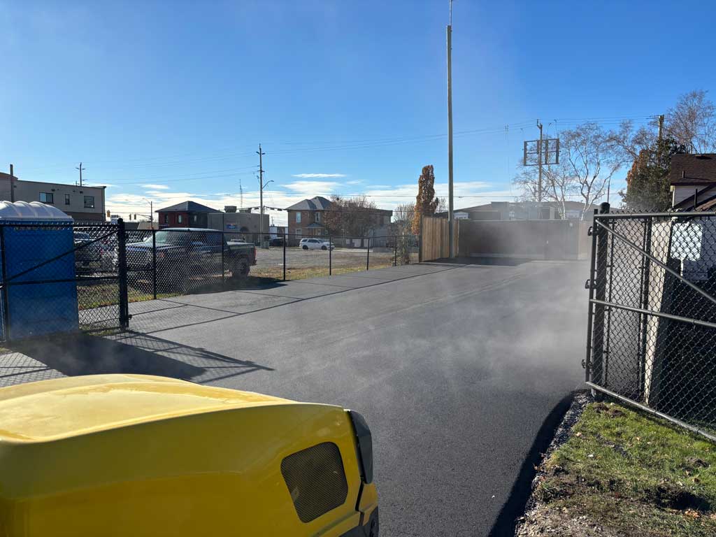 Finishing Commercial paving project, roller packing asphalt