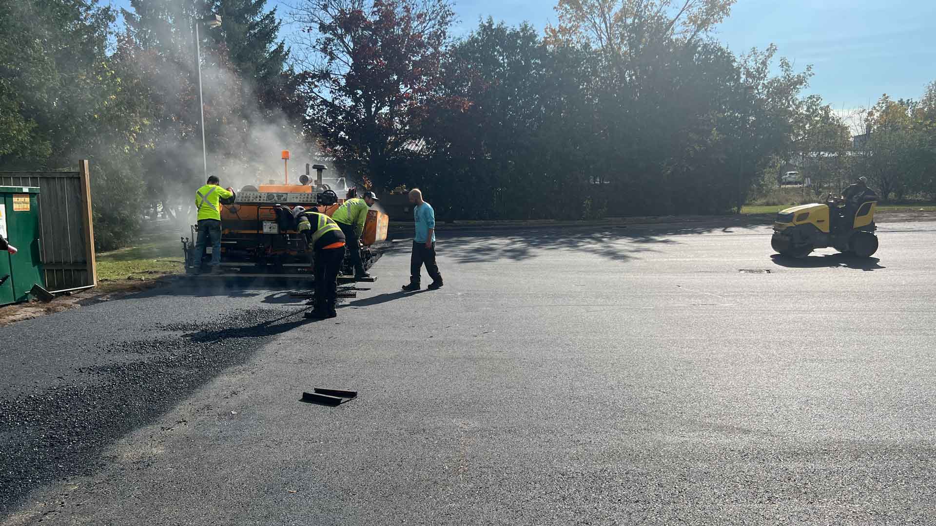 Genesis team paving end of a large parking lot
